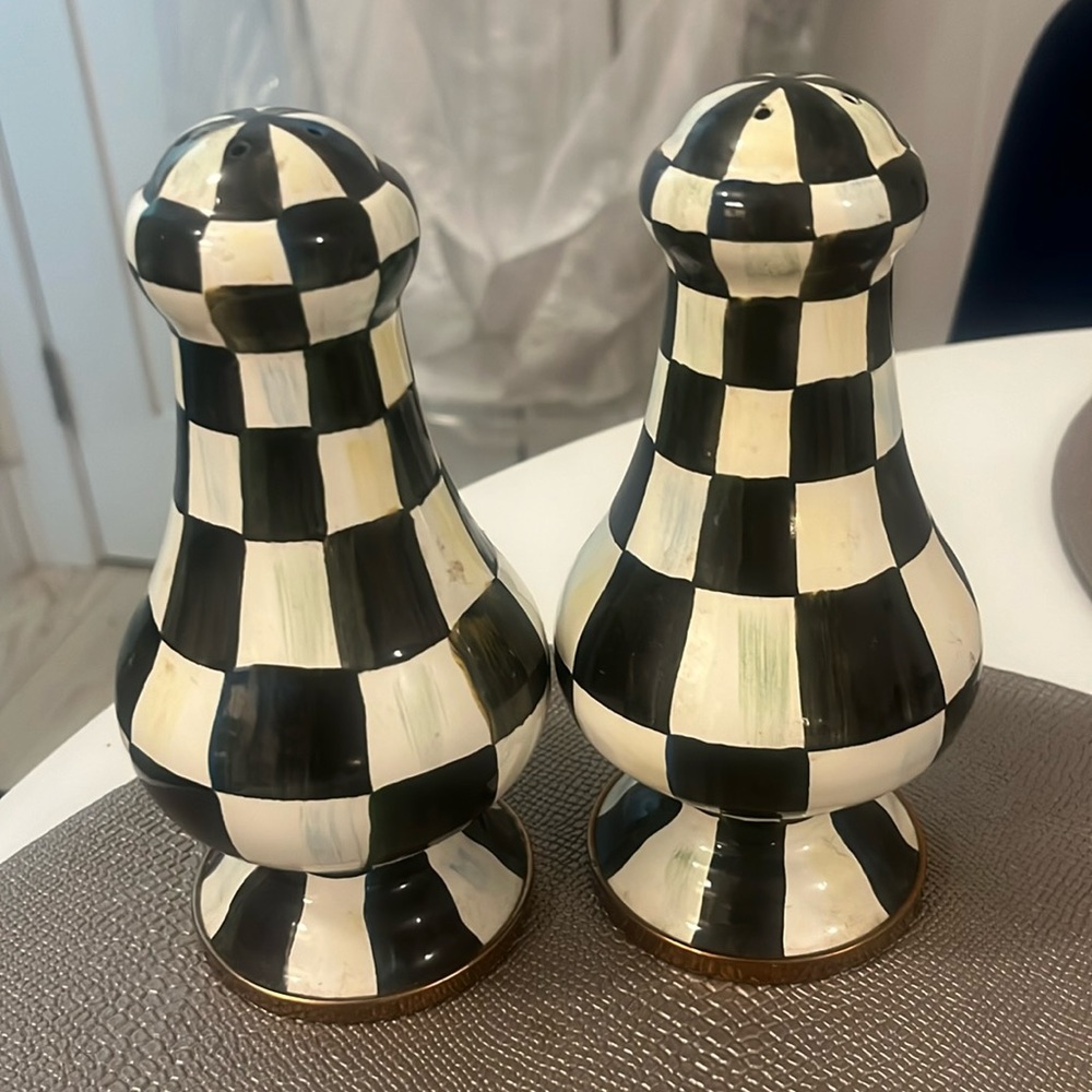 Two large salt and pepper shakers